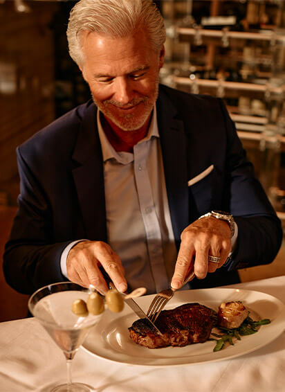 A man eating steak at Council Oak