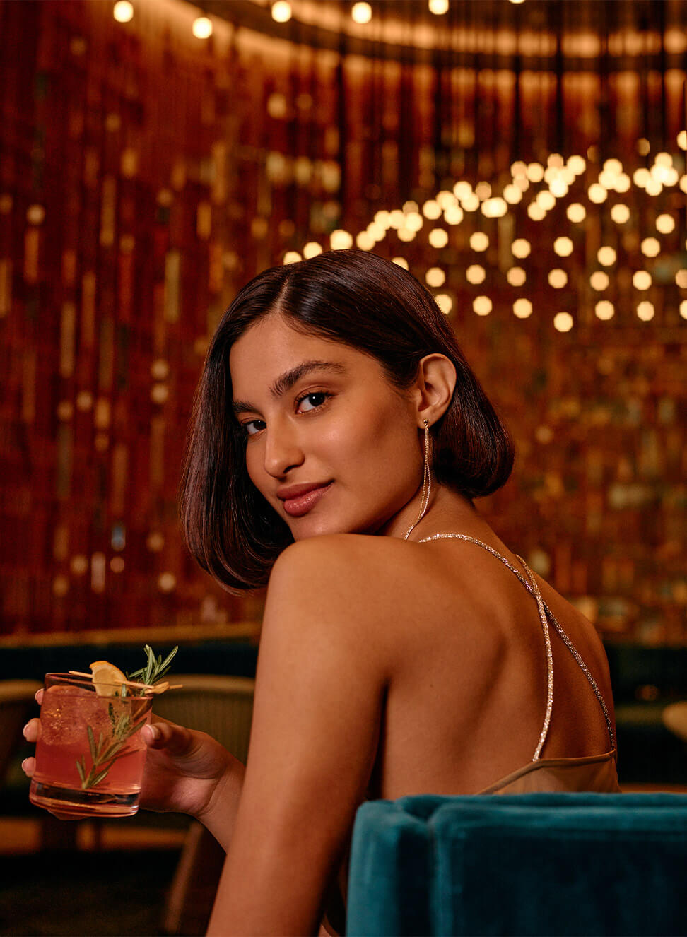 A woman enjoying her drink at the Oculus Bar